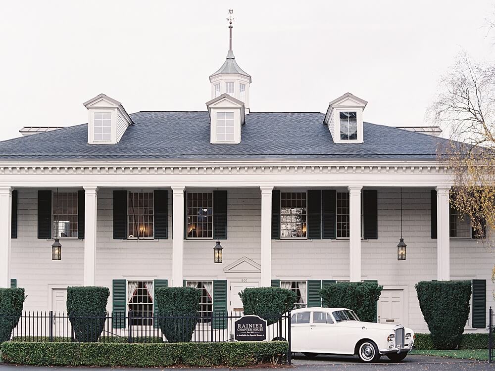 White brick mansion with green shutters and a white Rolls Royce in front for Seattle wedding photographed by Jacqueline Benét Photography