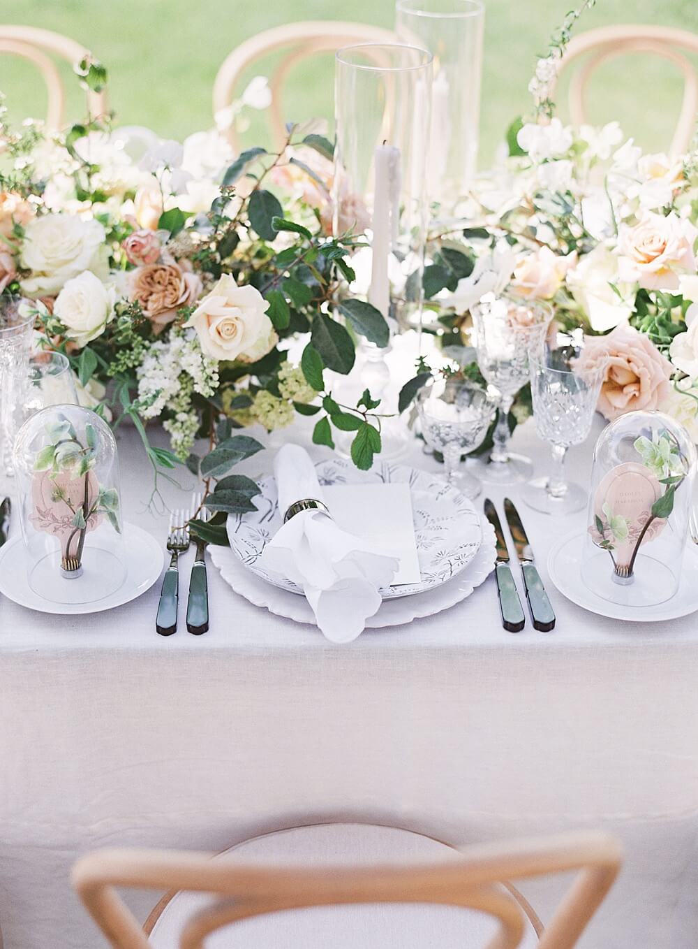 Peach cream and green romantic wedding tabletop florals with crystal and glass cloches at Cal-A-Vie wedding - Jacqueline Benét Photography