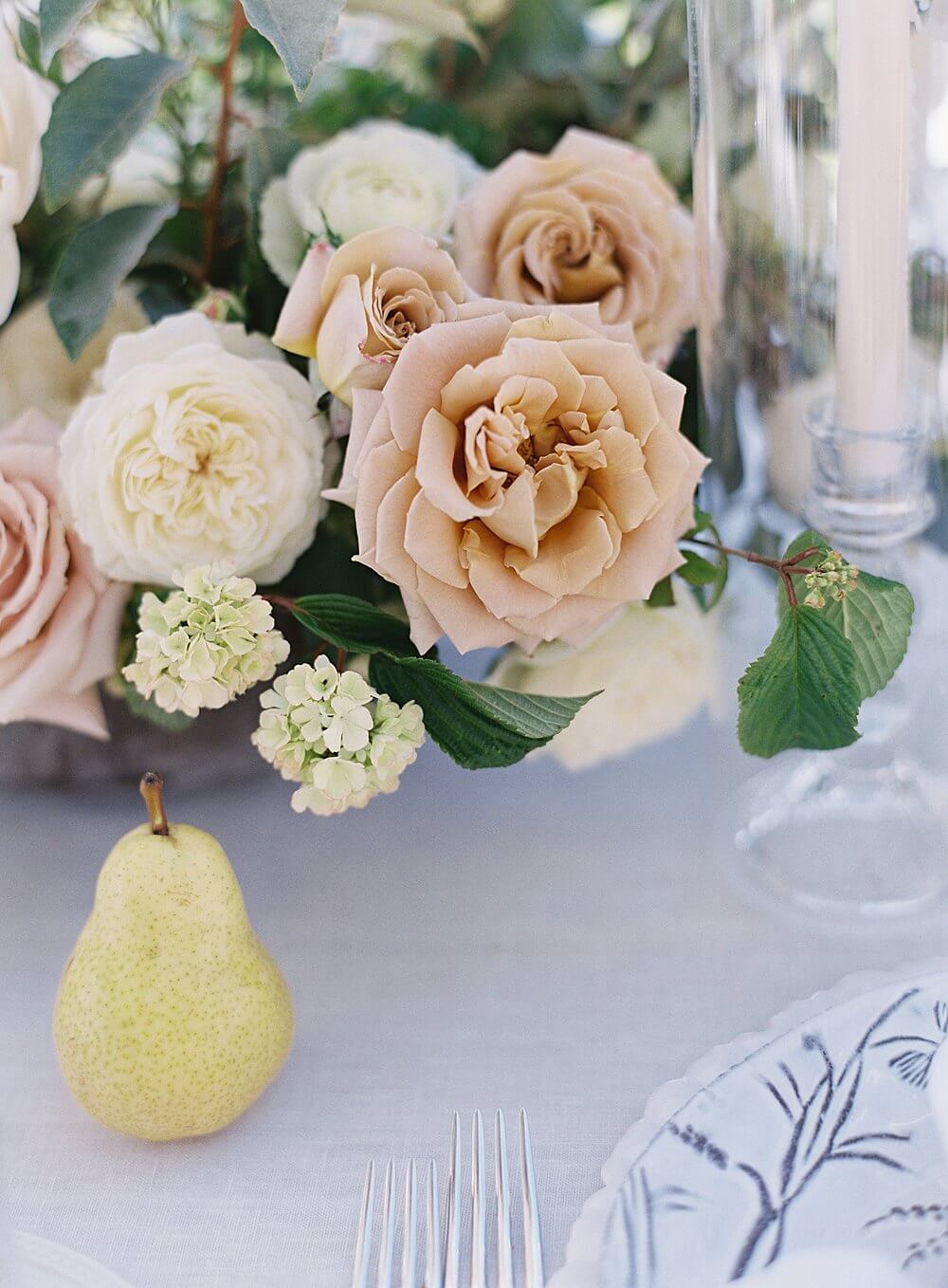 peach cream florals with pear on a wedding reception tabletop - Jacqueline Benét Photography