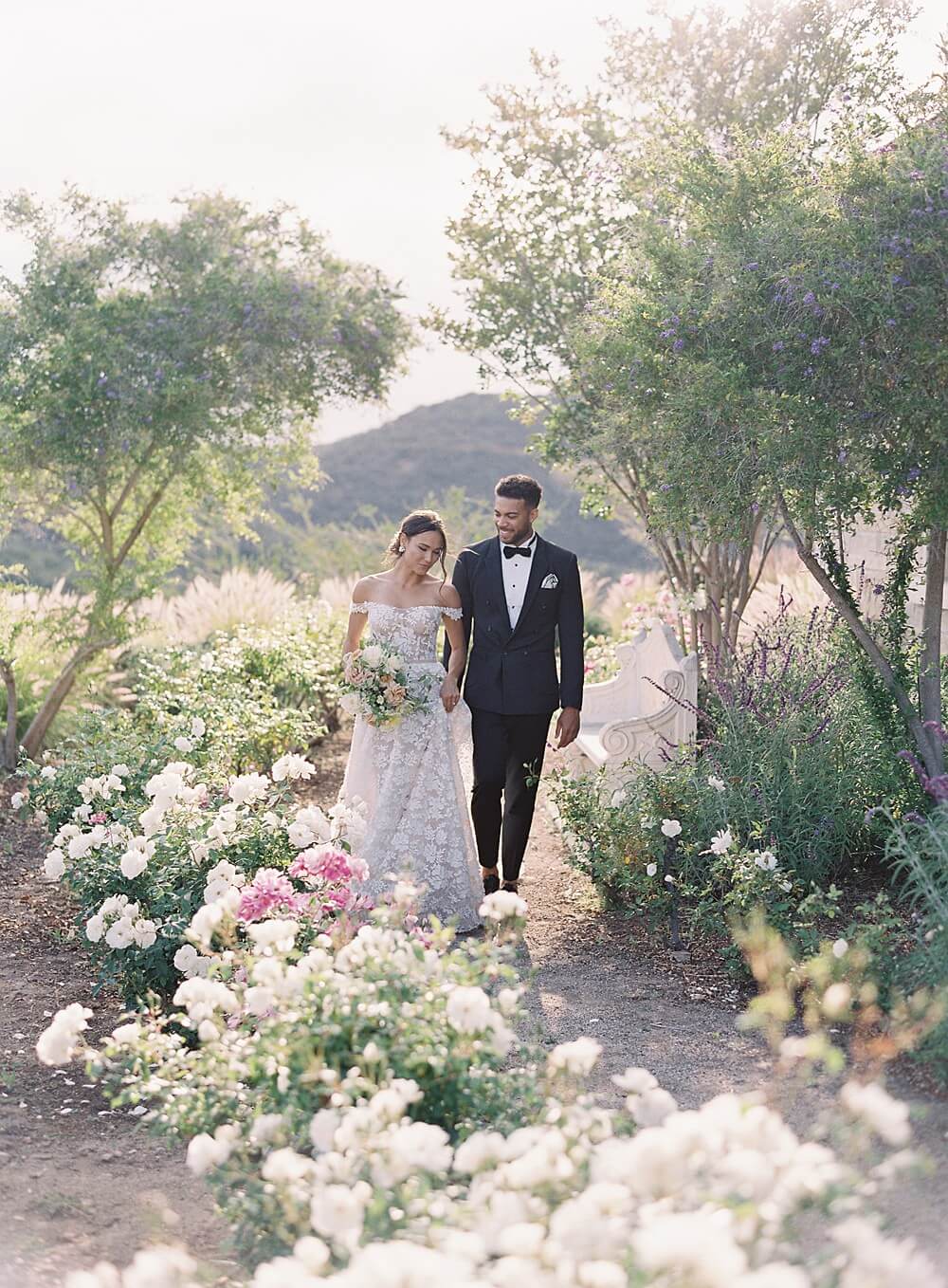 bride and groom walk through the rose garden at Cal-A-Vie spa wedding - Jacqueline Benét Photography