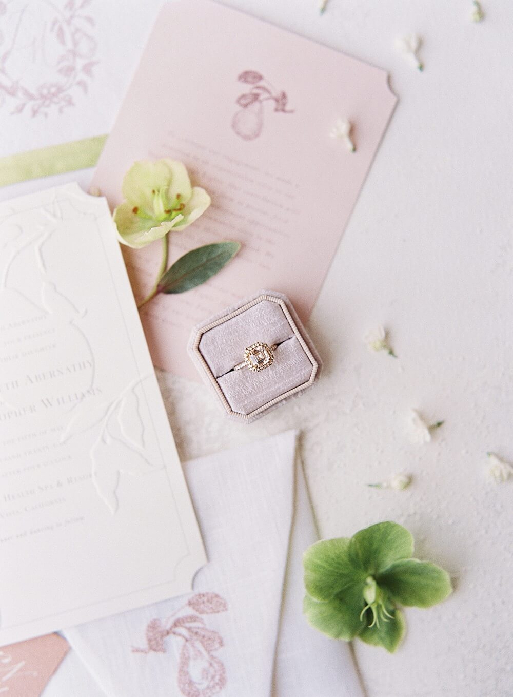 Halo square engagement ring in lavender linen mrs box on white and pink stationary with cream and green hellebore - Jacqueline Benét Photography