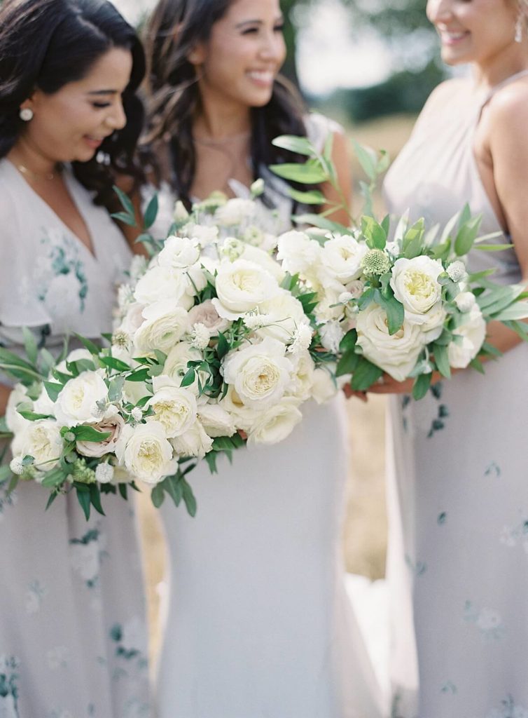 White bridal bouquet with bridesmaids in floral lavender dresses - Jacqueline Benét Photography