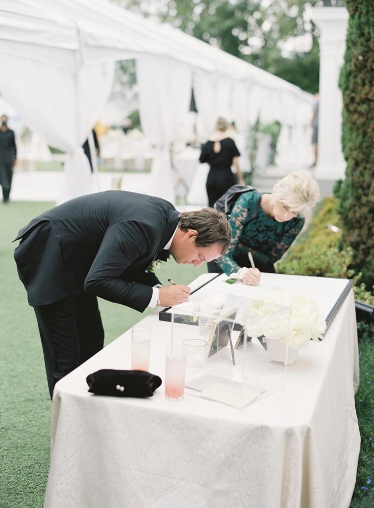 Guests sign guestbook at Admirals House during wedding in Seattle - Jacqueline Benét Photography