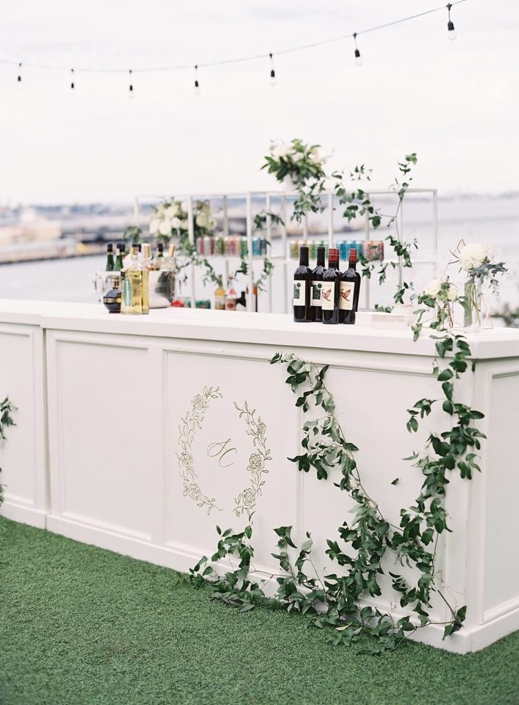 Cocktail hour bar with custom crest logo overlooking Seattle at Admirals House wedding - Jacqueline Benét Photography