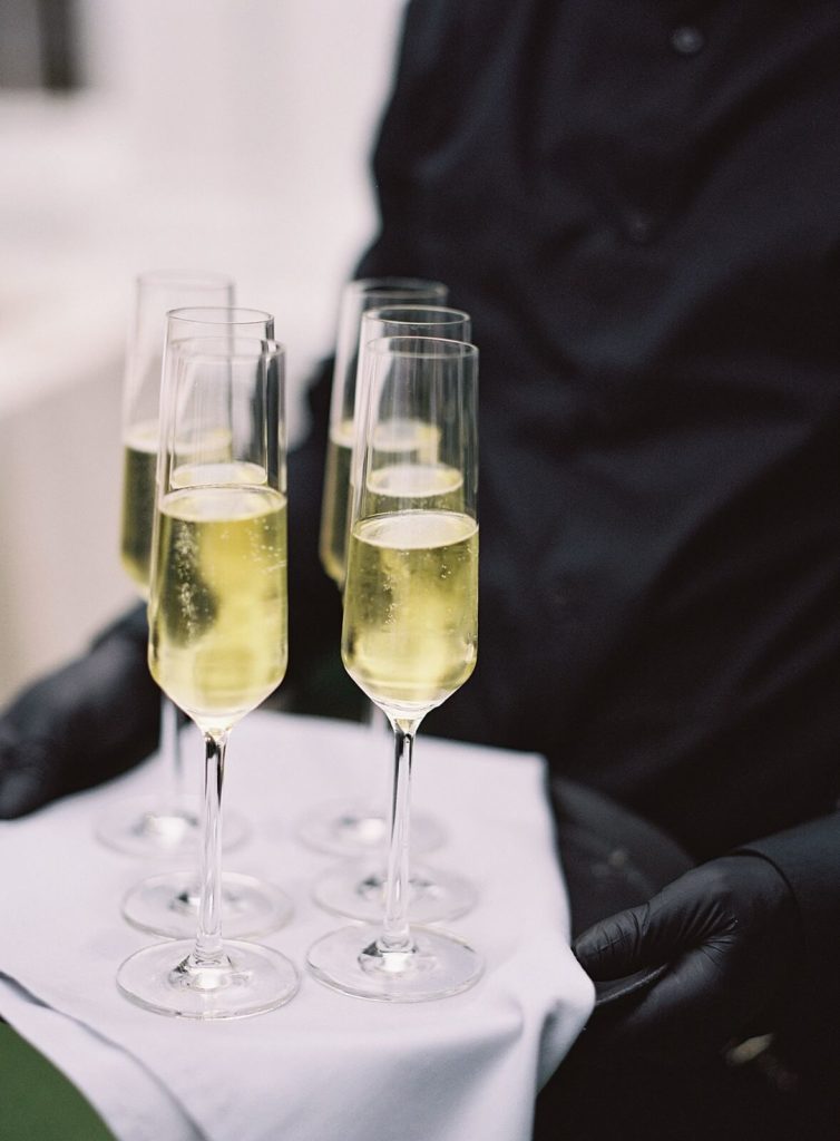 Champagne glasses during cocktail hour at Admirals House wedding - Jacqueline Benét Photography