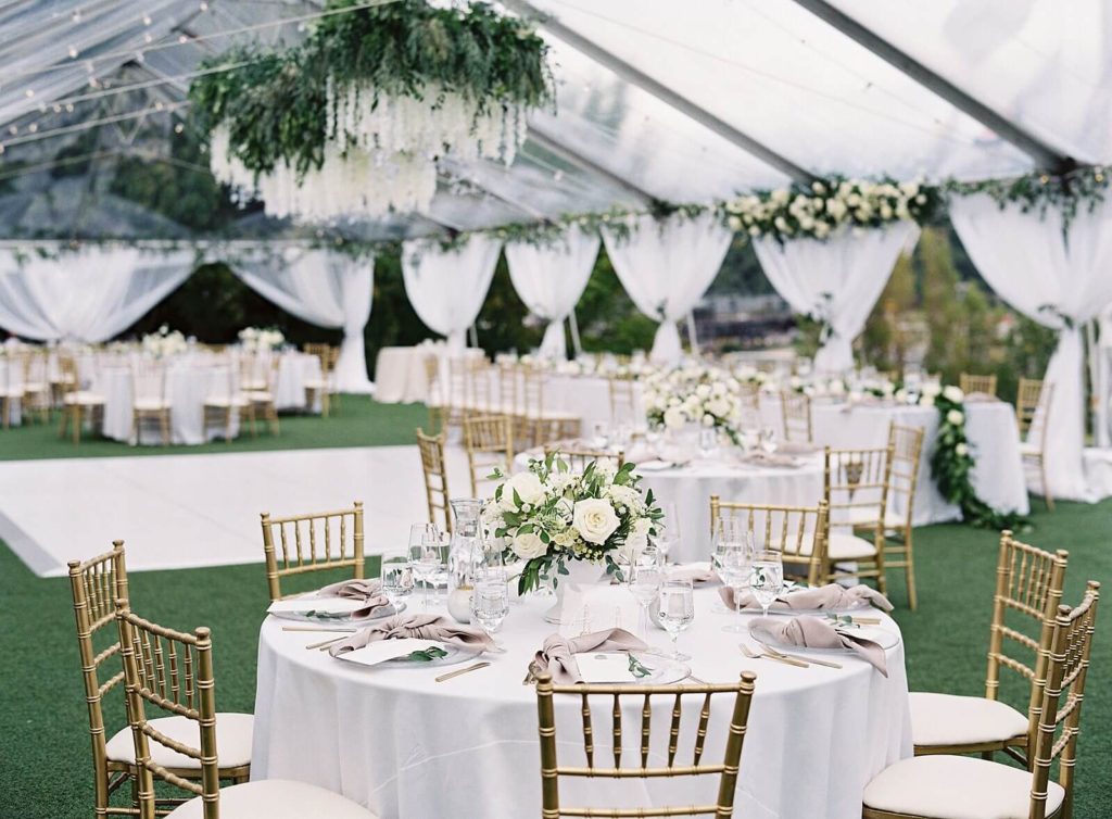 Gold chivari chairs and white florals at Admirals House wedding reception under clear tent -Jacqueline Benét Photography
