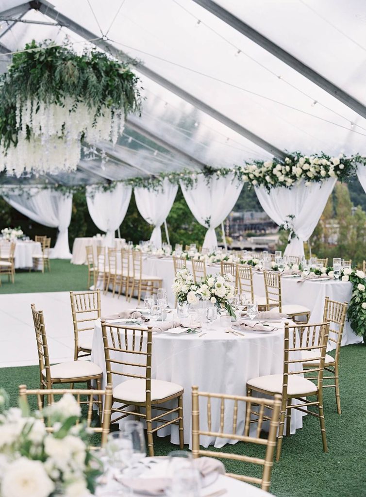 Reception under clear tent with white florals and gold chivari chairs for classic Admirals House wedding - Jacqueline Benét Photography