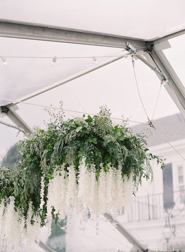 White floral hanging crane reception centerpiece under clear tent at Admirals House wedding - Jacqueline Benét Photography