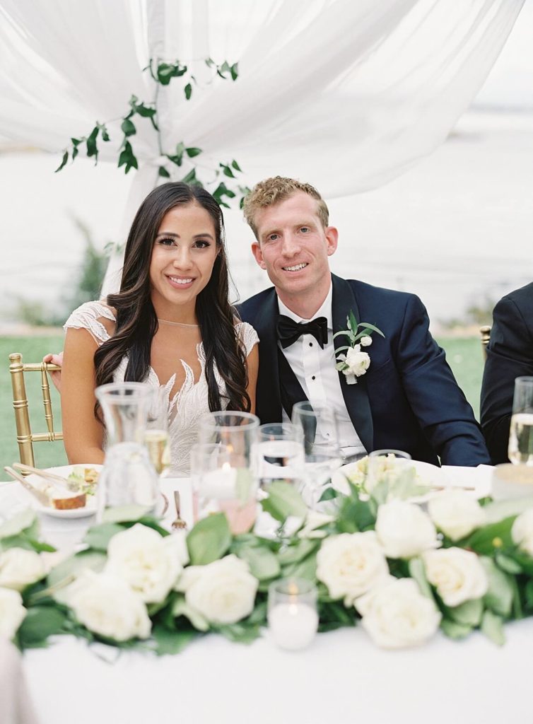 Bride and groom at reception table at Admirals House wedding in Seattle - Jacqueline Benét Photography