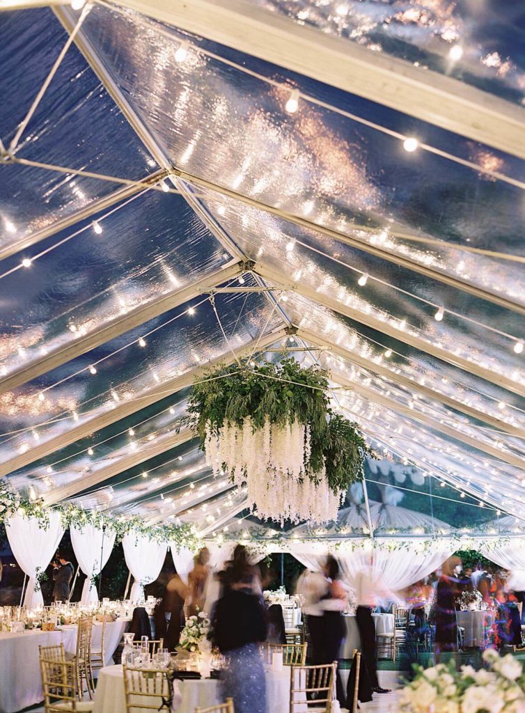 Blurry movement of wedding guests dancing under clear tent for wedding reception at Admirals House - Jacqueline Benét Photography