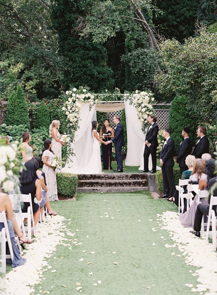 Ceremony at Admirals House wedding with white floral chuppah - Jacqueline Benét Photography