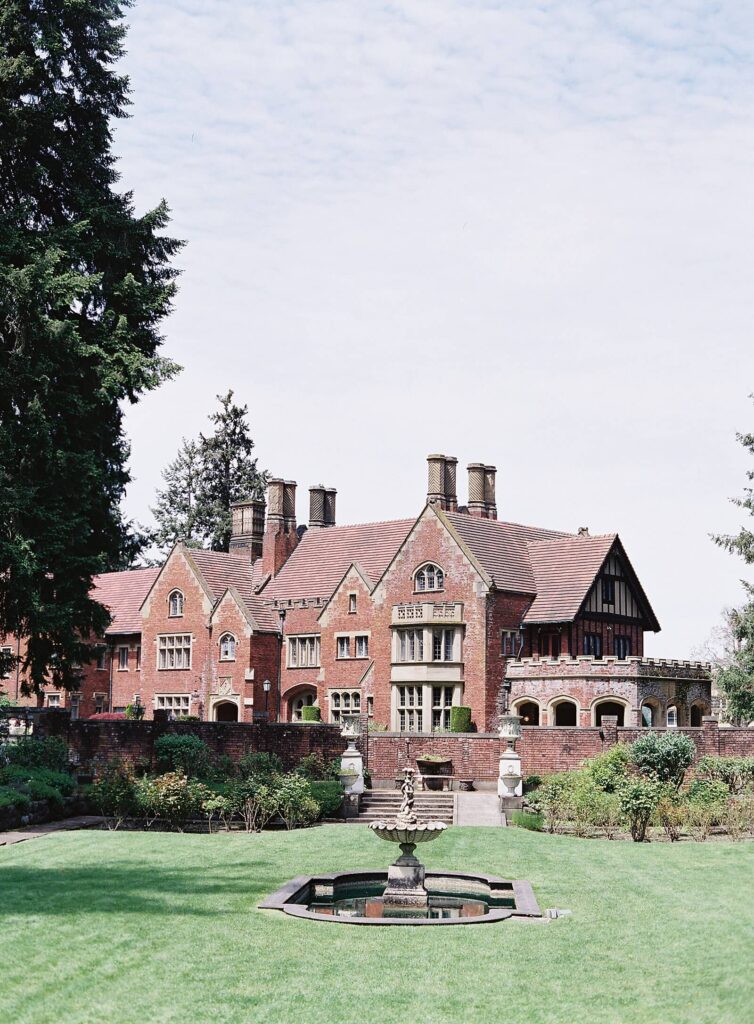 Brick castle with manicured garden and fountain on a sunny day for a Seattle wedding photographed by Jacqueline Benét Photography