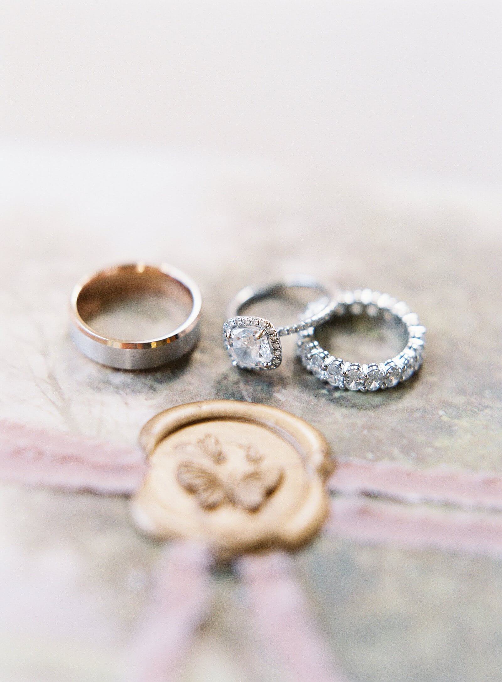 Wedding rings on romantic wedding stationary with bridal details - Jacqueline Benét Photography