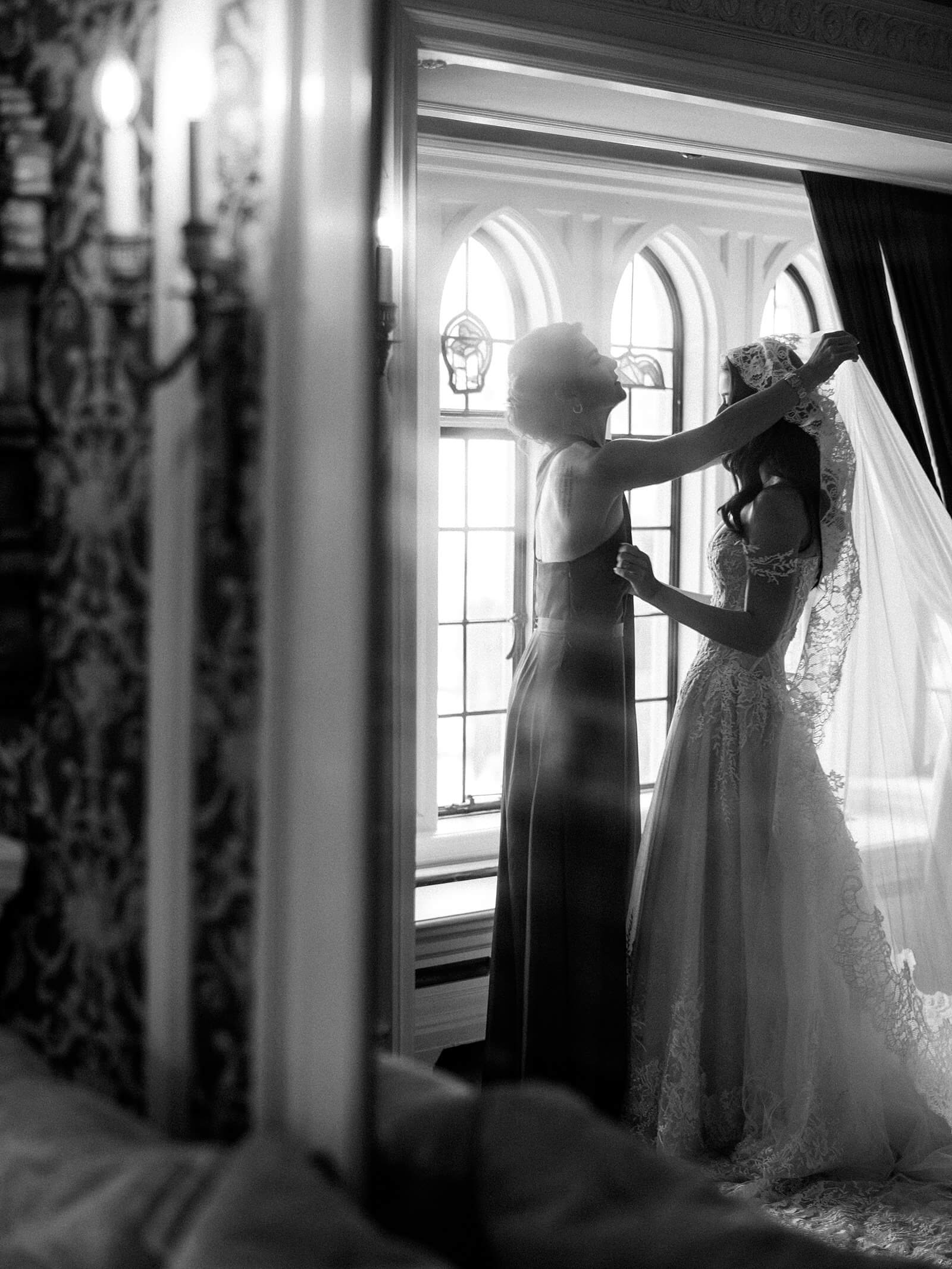 Mother of bride puts on veil of bride in Ines di Santo in black and white - Jacqueline Benét Photography