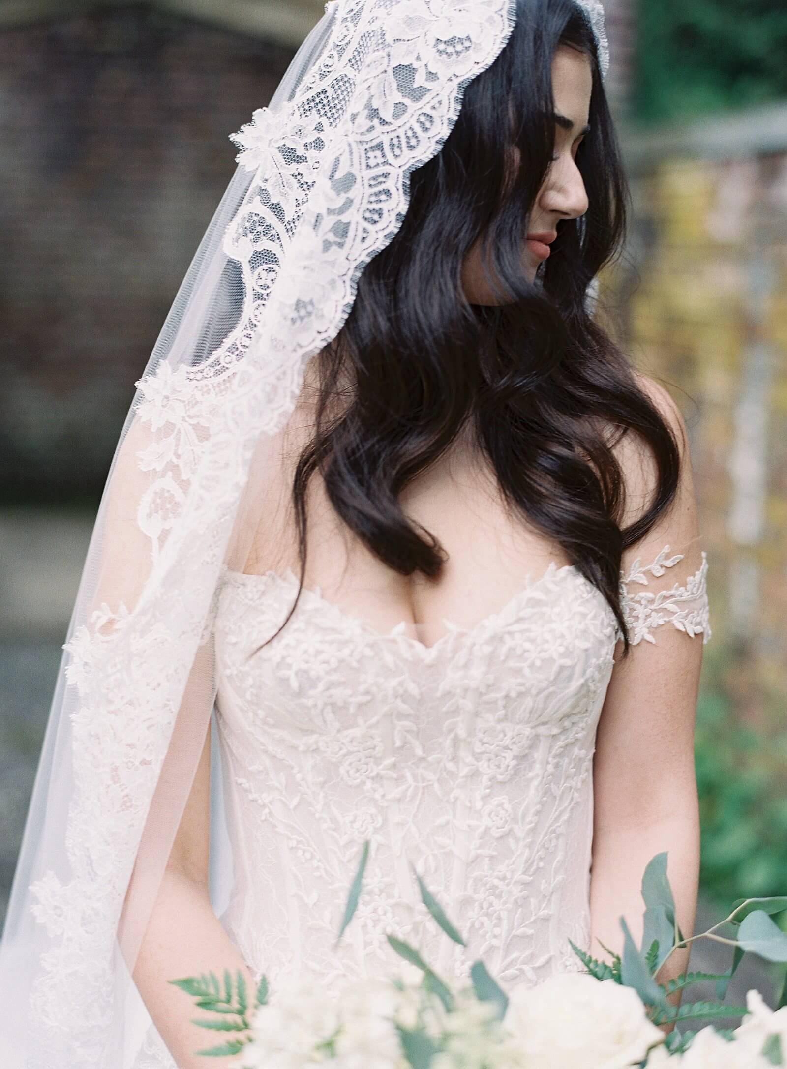 Bride with dark brunette long hair waves in mantilla lace veil and Ines di Santo applique gown - Jacqueline Benét Photography