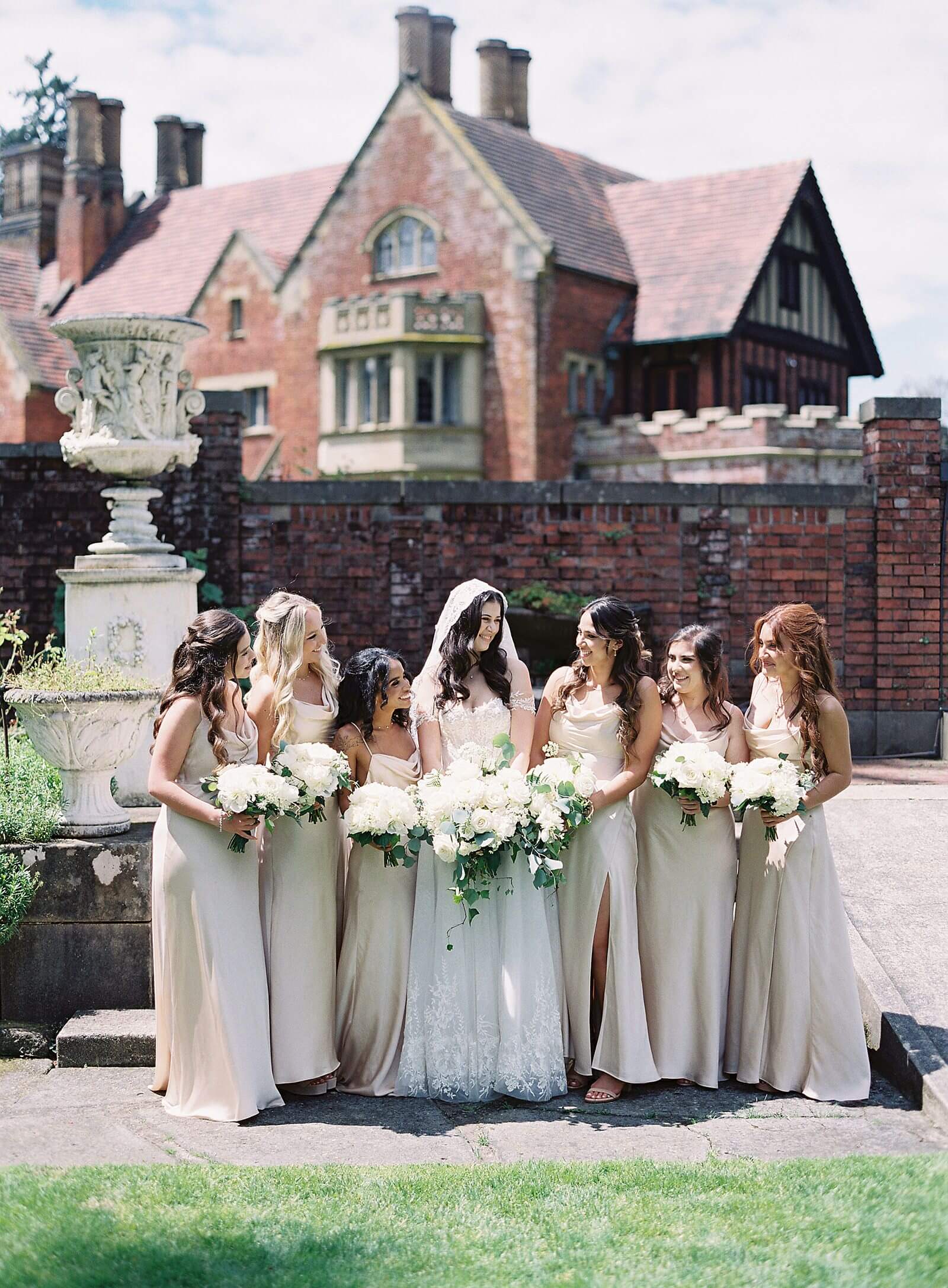Bride with bridesmaids in champagne gowns at Thornewood Castle - Jacqueline Benét Photography