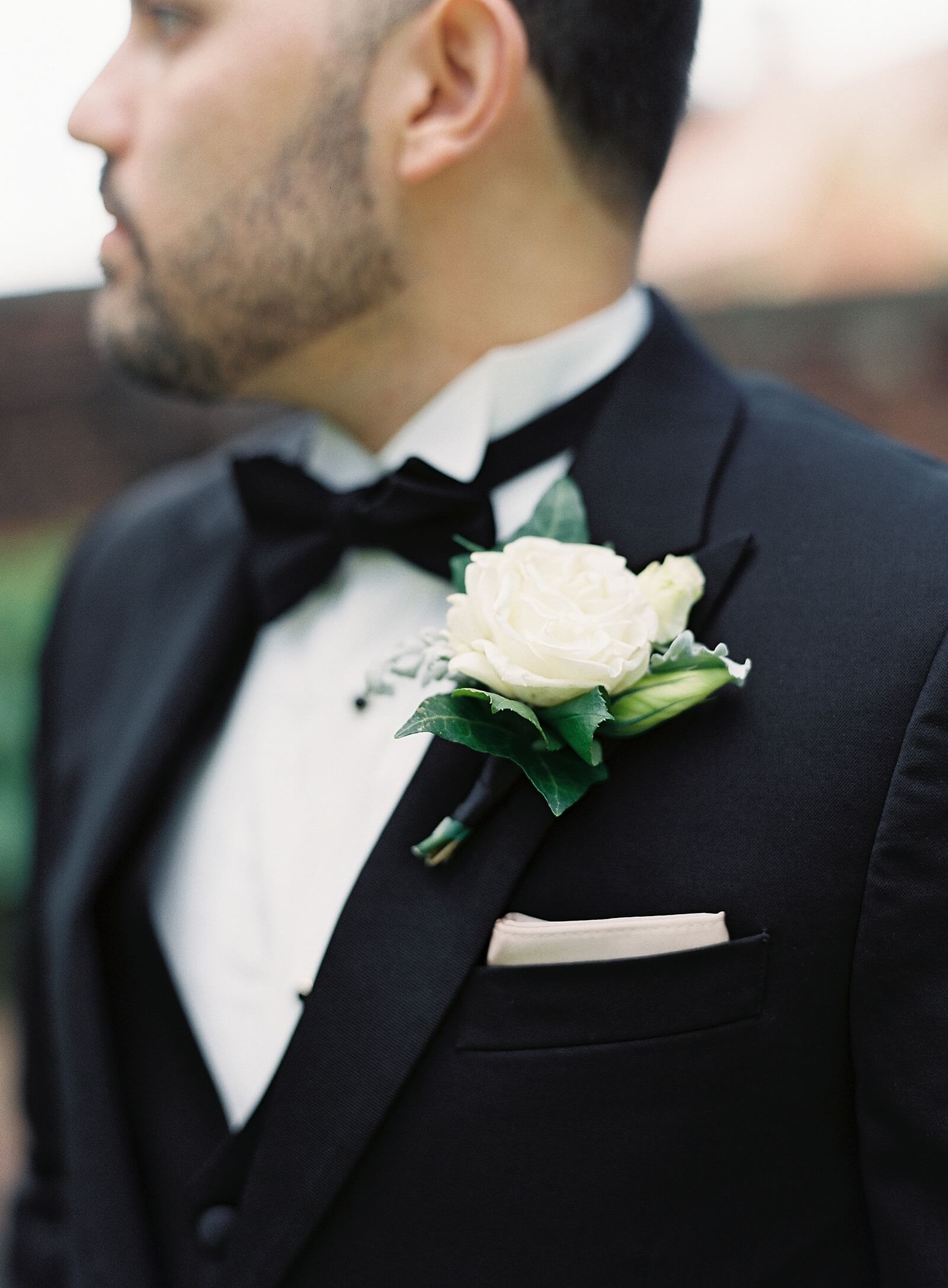 White rose boutonniere on groom in black tux - Jacqueline Benét Photography 