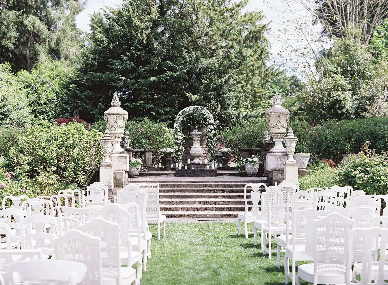 Thornewood Castle ceremony with mismatched white chairs - Jacqueline Benét Photography