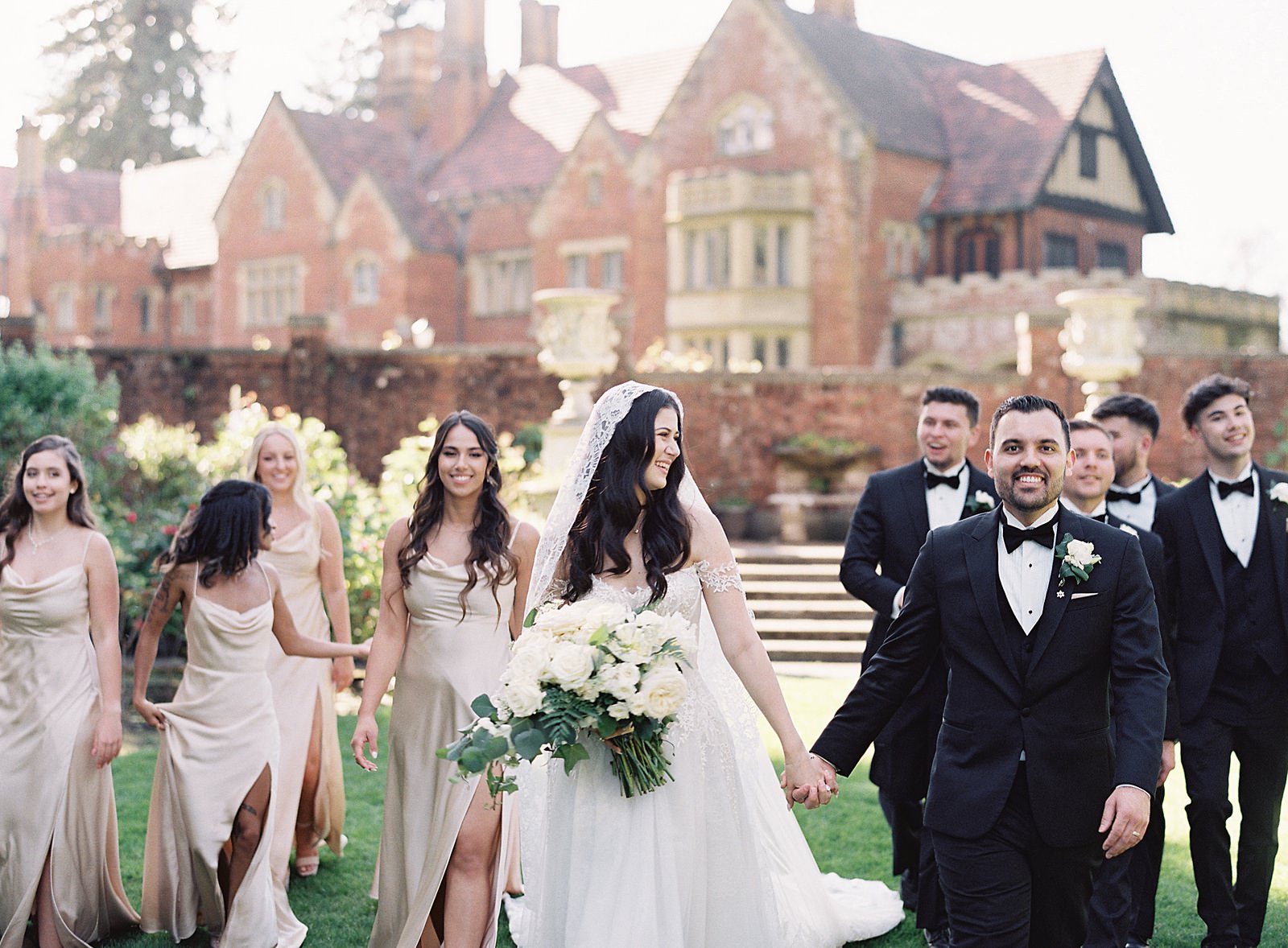 Bridal party with bride and groom walking in front of Thornewood Castle - Jacqueline Benét Photography