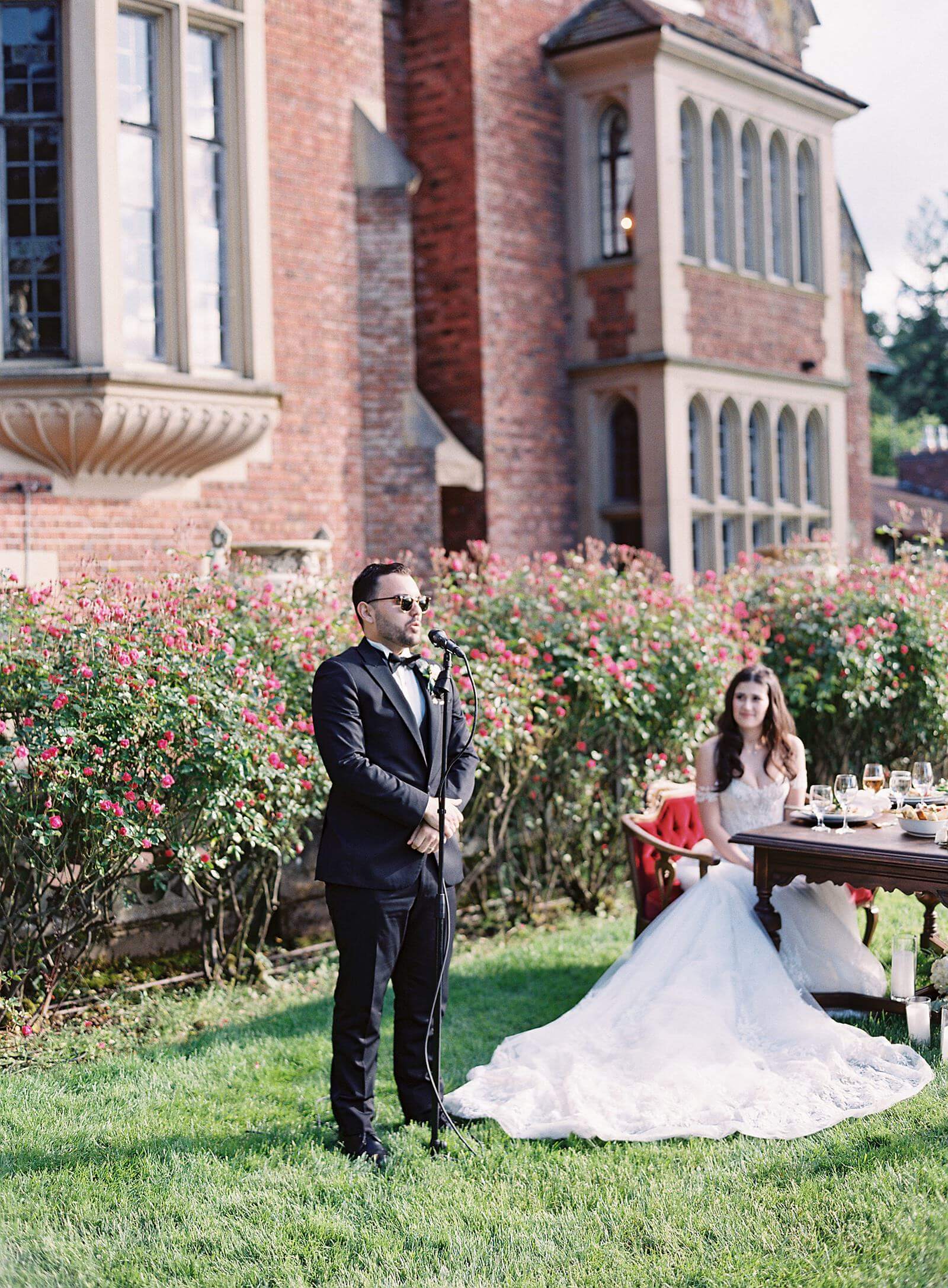 Groom gives toast outside Thornewood Castle wedding reception - Jacqueline Benét Photography