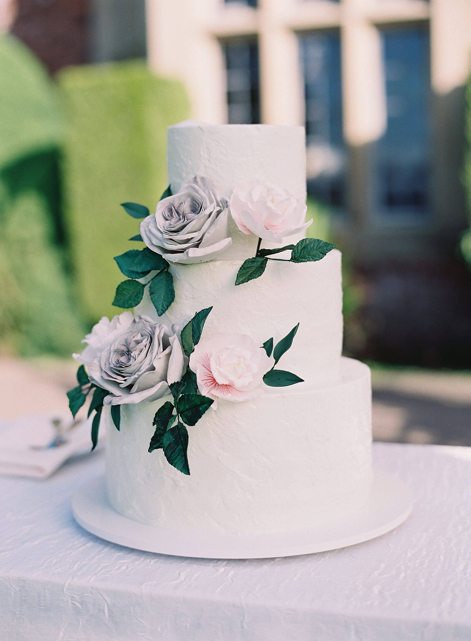 White three tiered wedding cake with faux sugar flowers - Jacqueline Benét Photography