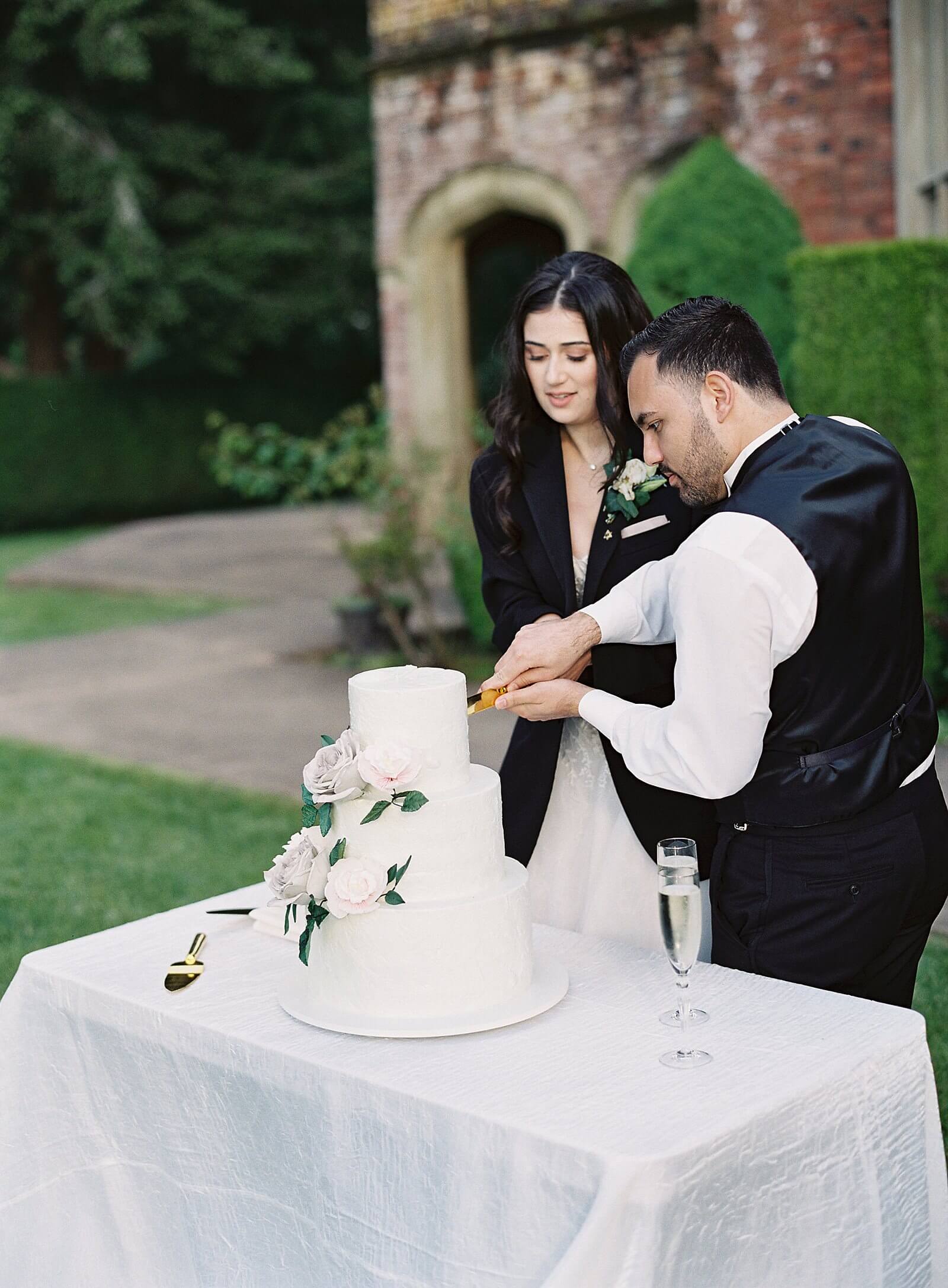 Bride and groom cut their wedding cake at Thornewood Castle -Jacqueline Benét Photography