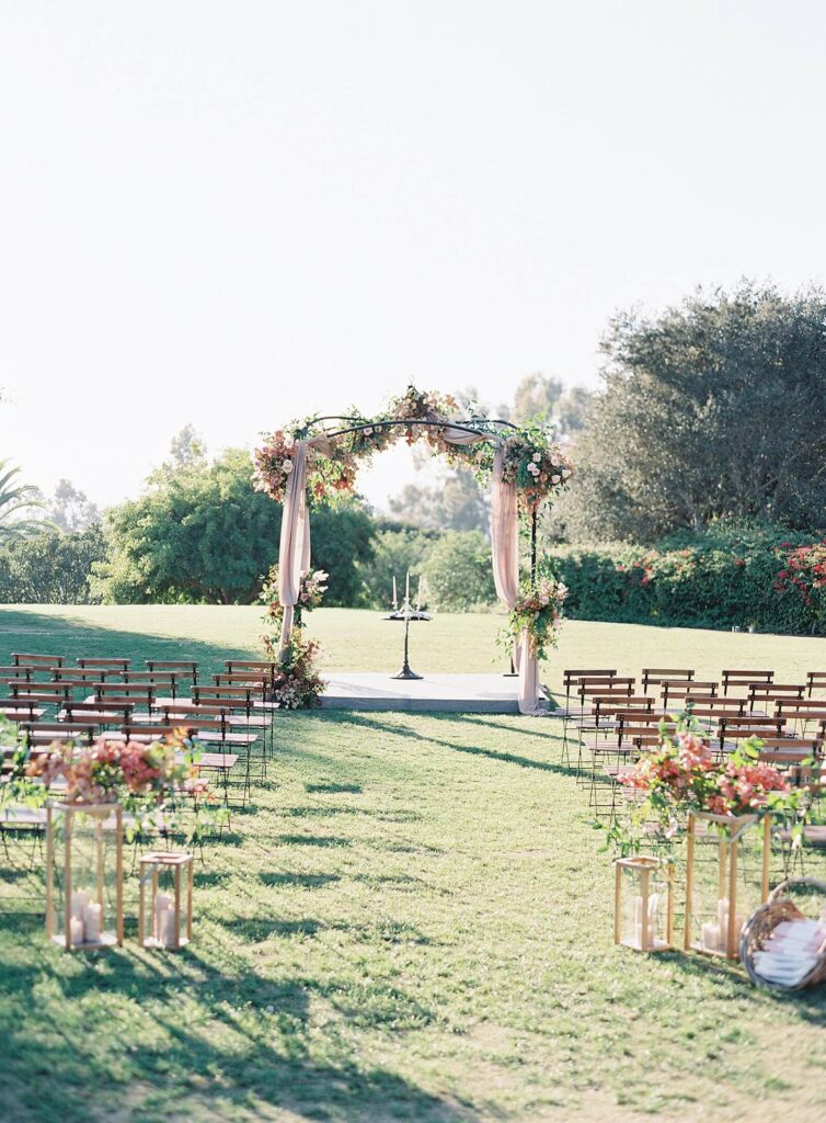 Pink floral chuppah with pink drapery at Rancho Valencia wedding ceremony - Jacqueline Benet Photography