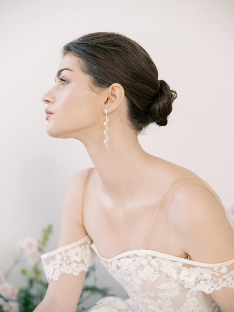 Close up photo of bride looking off into the distance on Fuji GFX camera in lace gown, photo by Jacqueline Benet Photography