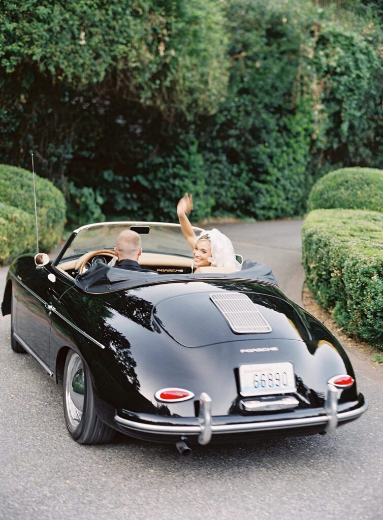 Bride and groom getaway in Porsche convertible with Jacqueline Benét Photography