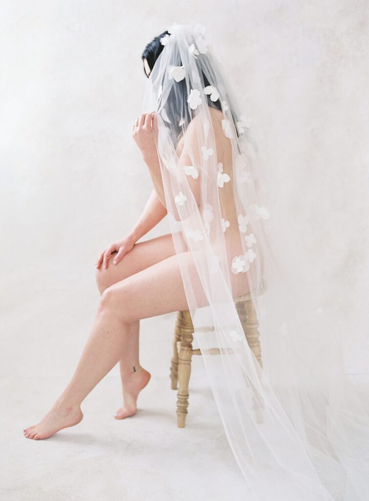 woman posing in veil at bridal boudoir session in seattle