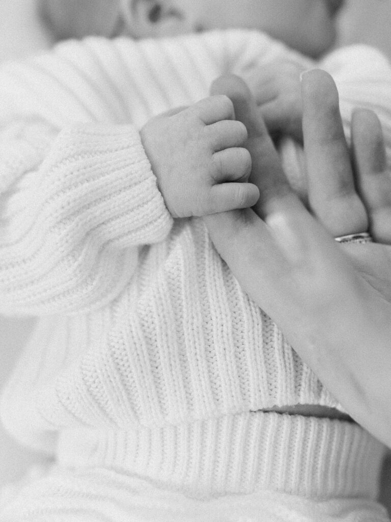 newborn baby fingers grab moms hand