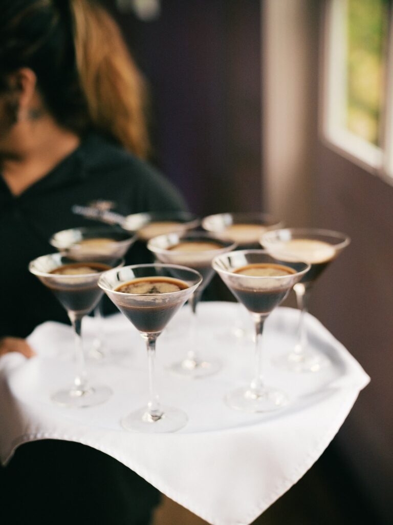 Tray of espresso martinis being served at the reception during a Harmony Meadows wedding celebration.