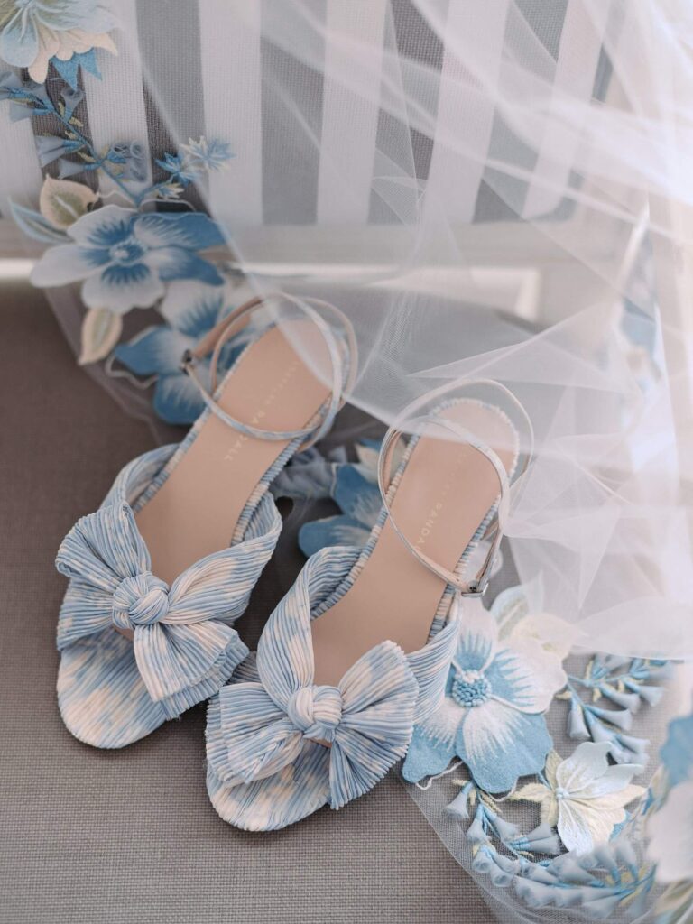 A close of of the beautiful pastel blue and white heels the bride is wearing on her wedding day at her garden wedding at fox hollow farm. Seattle wedding photography 