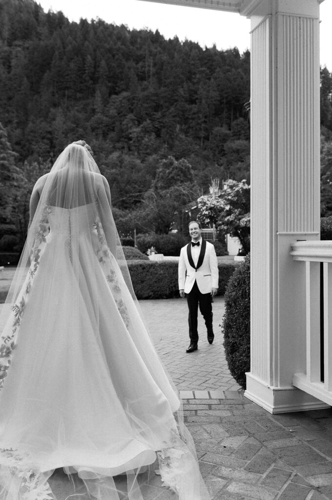 The first look between a classic bride and groom on the from porch of the Fox Hollow Farm wedding venue in Seattle, captured by Jacqueline Benét | fine art wedding portraits 