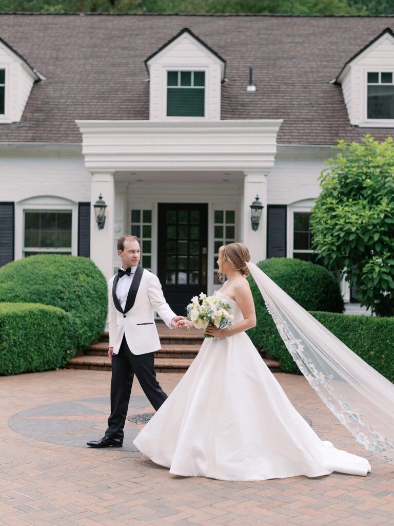 Bride and groom walking hand in hand through the garden paths at Fox Hollow Farm, captured in soft romantic light by Jacqueline Benét, Seattle wedding photographer | garden wedding at Fox Hollow Farm