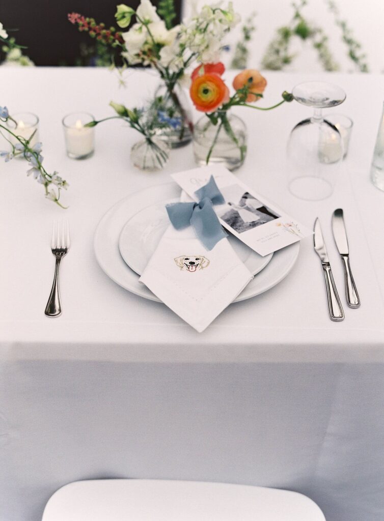 Detail photo of patterned linens, pastel florals, and elegant place settings inside the reception tent at Fox Hollow Farm, captured by Jacqueline Benét | garden wedding at Fox Hollow Farm