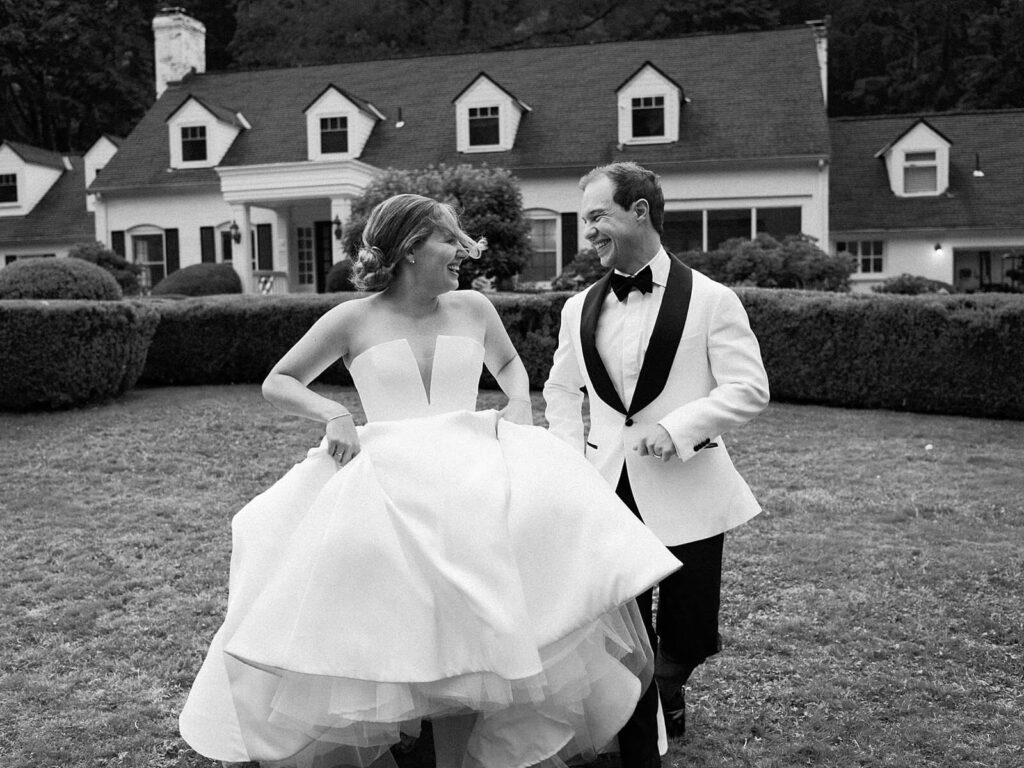 Bride and groom sharing a joyful moment after the ceremony in the gardens at Fox Hollow Farm, photographed by Jacqueline Benét | Seattle wedding photography