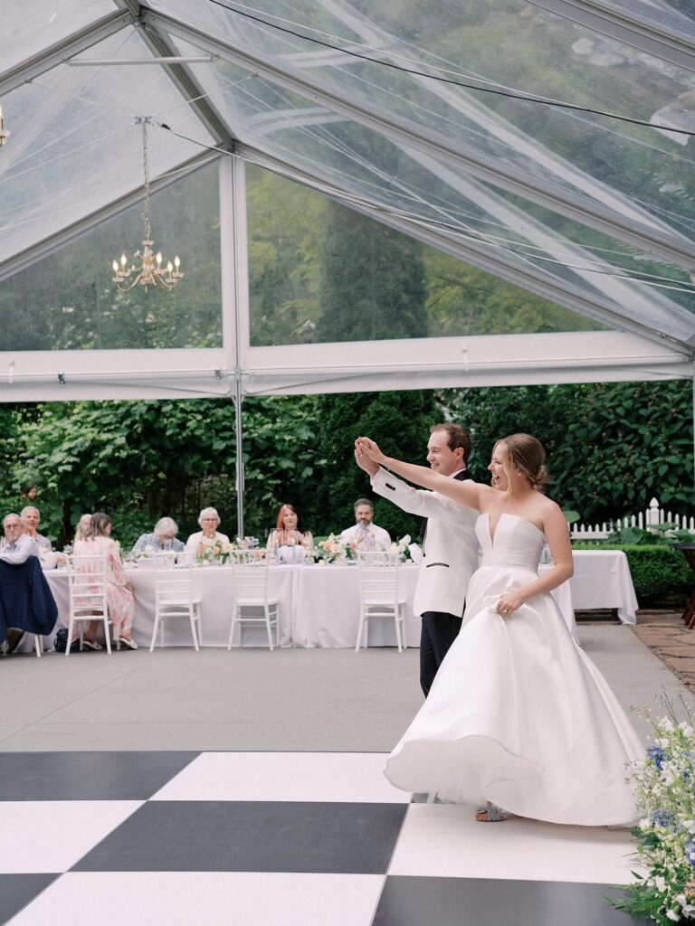 Bride and groom sharing their first dance beneath sparkling chandeliers at Fox Hollow Farm, photographed by Jacqueline Benét | Fox Hollow Farm wedding
