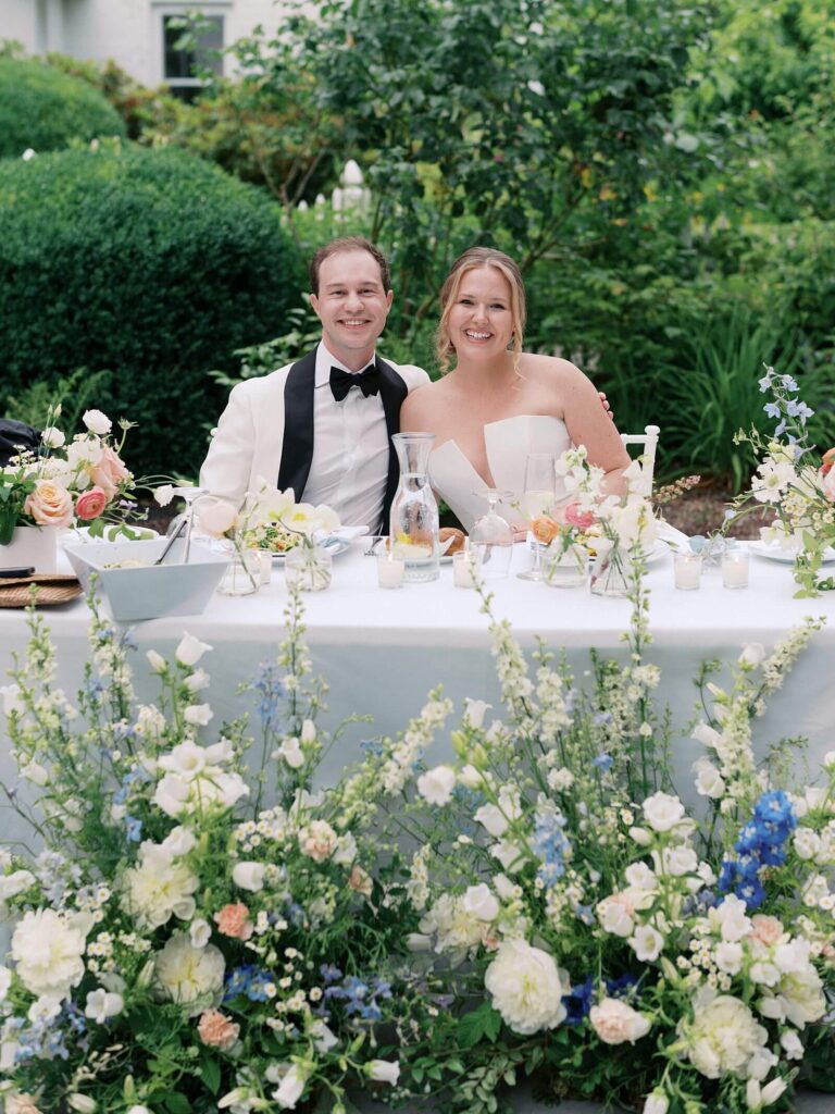 The bride and groom seated together and smiling during their wedding reception at Fox Hollow Farm wedding venue in Seattle - one of the top outdoor wedding venues in Seattle 