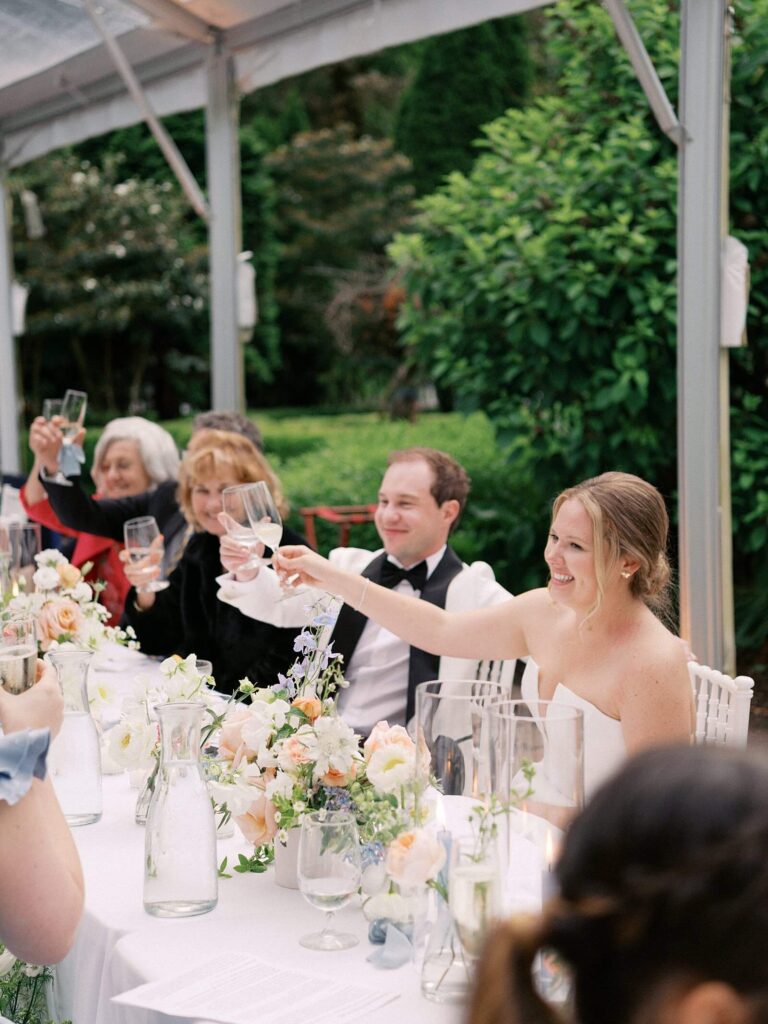 Guests mingling with signature cocktails beneath the chandeliers of the Fox Hollow Farm tented reception, captured by Jacqueline Benét | Seattle wedding photography