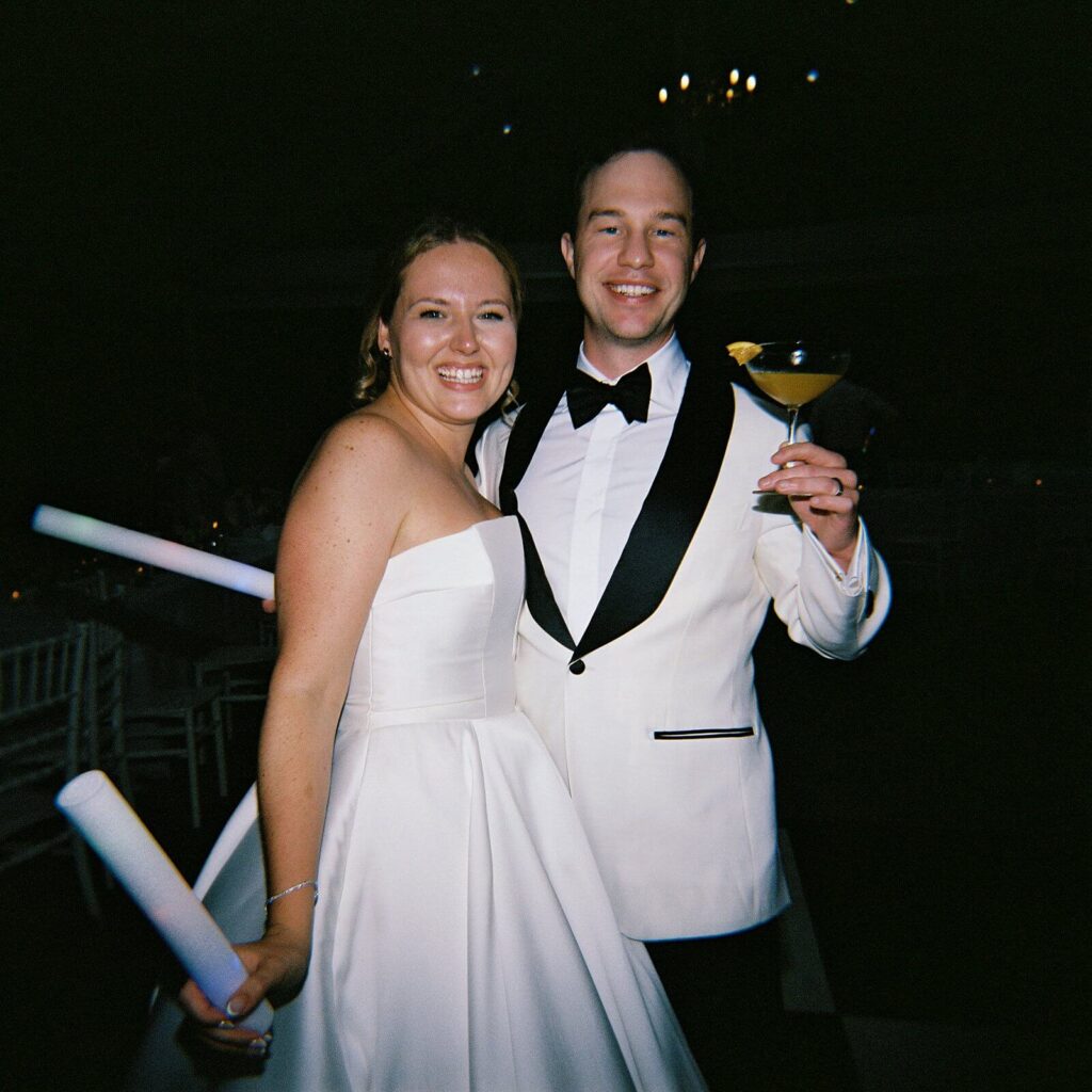 The bride and groom smiling together after taking a break from the dancing to get a cocktail during their wedding at Fox Hollow Farms - Seattle wedding photos 