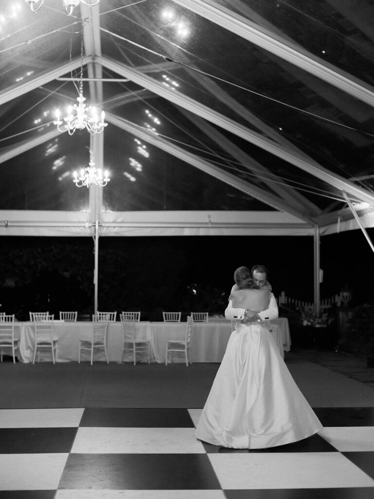 Private last dance on the empty checkered dance floor at Fox Hollow Farm, a tender moment documented by Jacqueline Benét | garden wedding at Fox Hollow Farm
