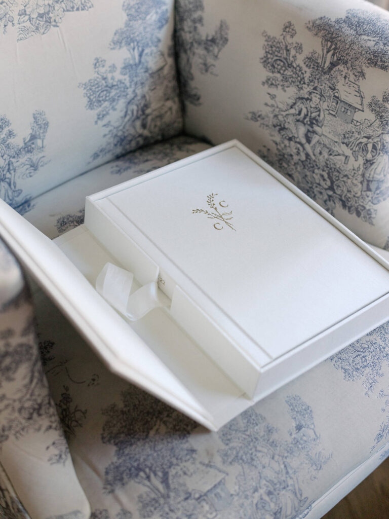 Photo of a beautiful, classic, linen bound heirloom wedding album in a protective case. Showcasing the importance of having an heirloom wedding album made to preserve your wedding day. Captured by Jacqueline Benét, Seattle wedding photographer