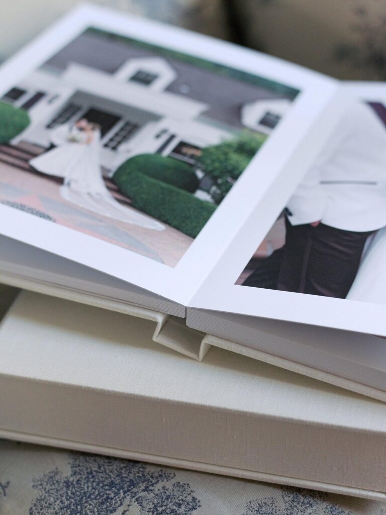 Photo of a classic heirloom wedding photo album opened up to a portrait of a Seattle bride and groom. Captured by Seattle wedding photographer, Jacqueline Benét