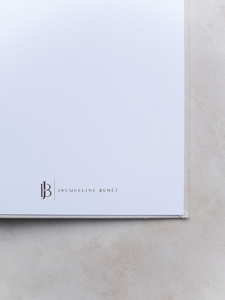 Image of the final page of an heirloom photo album for a Seattle couple's wedding. This final page has the wedding photographer, Jacqueline Benét's logo in the bottom margin.